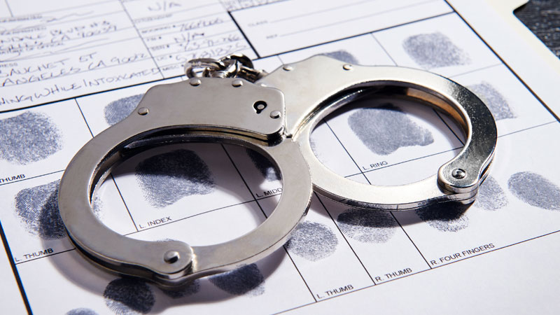 photo of handcuffs on a booking slip